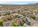 An aerial view showcases a suburban community with well-maintained homes, desert landscaping, and mountain views at 249 Cinnamon Ridge Way, Henderson, NV 89015