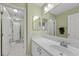 Bathroom featuring a white vanity with a sink and multiple mirrors. Includes a view of a separate toilet room at 249 Cinnamon Ridge Way, Henderson, NV 89015