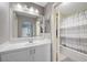 Bathroom with a white vanity and a large mirror above the sink. Includes a shower and tub at 249 Cinnamon Ridge Way, Henderson, NV 89015