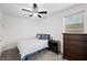 Bright bedroom with carpet flooring, a ceiling fan, and a dresser at 249 Cinnamon Ridge Way, Henderson, NV 89015