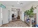 Bonus room with tile flooring, two fridges, access to another room, and many plants at 249 Cinnamon Ridge Way, Henderson, NV 89015