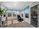 Bright bonus room with many windows and tile flooring. Includes a drink fridge and massage chair at 249 Cinnamon Ridge Way, Henderson, NV 89015