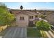 Two story home features a three car garage, well manicured front lawn and tasteful desert landscaping at 249 Cinnamon Ridge Way, Henderson, NV 89015