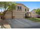Two-story home featuring a three-car garage, well-manicured lawn, and mature landscaping at 249 Cinnamon Ridge Way, Henderson, NV 89015