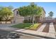Two-story home with a three-car garage, lawn, and mature trees at 249 Cinnamon Ridge Way, Henderson, NV 89015