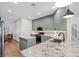 Bright, modern kitchen with gray cabinets, granite countertops, stainless appliances, and an island at 249 Cinnamon Ridge Way, Henderson, NV 89015