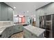 Bright kitchen with gray cabinets, granite countertops, stainless steel appliances, and pendant lighting at 249 Cinnamon Ridge Way, Henderson, NV 89015