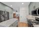 Well-lit kitchen with gray cabinets, stainless steel appliances, granite countertops, and hardwood floors at 249 Cinnamon Ridge Way, Henderson, NV 89015