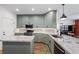 Modern kitchen with gray cabinets, granite countertops, stainless steel appliances, and kitchen island at 249 Cinnamon Ridge Way, Henderson, NV 89015