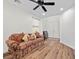 Bright living room with hardwood floors, neutral walls, a patterned sofa, and natural light at 249 Cinnamon Ridge Way, Henderson, NV 89015