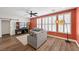 Cozy living room with abundant natural light, ceiling fan, and wood-look flooring at 249 Cinnamon Ridge Way, Henderson, NV 89015