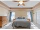 Comfortable main bedroom with large windows, carpet flooring, and decorative lighting at 249 Cinnamon Ridge Way, Henderson, NV 89015