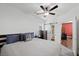 Main bedroom with barn door, ceiling fan, and view to bathroom at 249 Cinnamon Ridge Way, Henderson, NV 89015