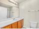 Bright bathroom with a well lit mirror over the sink and vanity, plus a toilet at 2558 Lazy Saddle Dr, Henderson, NV 89002