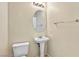 Neat half-bathroom showcasing a pedestal sink, toilet, and overhead lighting at 2558 Lazy Saddle Dr, Henderson, NV 89002