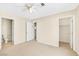 Neutral bedroom with carpet flooring, ceiling fan, and walk-in closet at 2558 Lazy Saddle Dr, Henderson, NV 89002