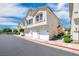 Charming townhome featuring multiple garages, complemented by well-maintained landscaping at 2558 Lazy Saddle Dr, Henderson, NV 89002