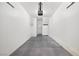 An empty garage featuring a cement floor, access door, shelving, and lighting at 2558 Lazy Saddle Dr, Henderson, NV 89002