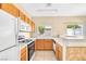 Bright kitchen featuring oak cabinets and white appliances at 2558 Lazy Saddle Dr, Henderson, NV 89002