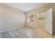 Inviting bedroom with light wood flooring, a bright window, and an adjacent closet space for easy organization at 2615 W Gary Ave # 1053, Las Vegas, NV 89123