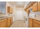 Efficient kitchen featuring wood cabinets, a suite of white appliances, and ample storage for culinary endeavors at 2615 W Gary Ave # 1053, Las Vegas, NV 89123