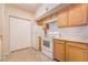 Efficient kitchen with white appliances, wood cabinets, and ample storage for cooking convenience at 2615 W Gary Ave # 1053, Las Vegas, NV 89123