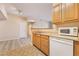 Cozy kitchen space with wood cabinets, stainless steel sink, and white appliances for everyday cooking needs at 2615 W Gary Ave # 1053, Las Vegas, NV 89123