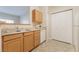 Functional kitchen with wood cabinets, stainless steel sink, and white appliances offering practical meal prep at 2615 W Gary Ave # 1053, Las Vegas, NV 89123