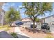 View of parking area with assigned parking, garage parking and mature landscaping at 2615 W Gary Ave # 1053, Las Vegas, NV 89123