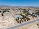 Expansive aerial view of a desert property with a home and large lot featuring mountain views at 2950 Winchester Ave, Pahrump, NV 89048