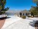Beautiful single-story home featuring a large driveway, mature trees, and three-car garage at 2950 Winchester Ave, Pahrump, NV 89048