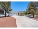Beautiful single-story home featuring a large driveway, mature trees, and three-car garage at 2950 Winchester Ave, Pahrump, NV 89048