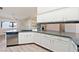 Modern kitchen with white cabinets, gray countertops, and a stainless steel refrigerator at 2950 Winchester Ave, Pahrump, NV 89048