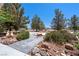 Stone pathway and desert landscaping adds beauty to this home's exterior at 2950 Winchester Ave, Pahrump, NV 89048
