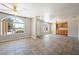 Spacious living room featuring tile floors, a ceiling fan, and a large picture window at 2950 Winchester Ave, Pahrump, NV 89048