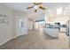 Bright living room open to kitchen features modern ceiling fan and wood-look floors at 2950 Winchester Ave, Pahrump, NV 89048