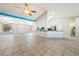 Open living area with vaulted ceiling, tile flooring, kitchen bar and natural light at 2950 Winchester Ave, Pahrump, NV 89048