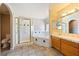 Spacious main bathroom includes a soaking tub, glass enclosed shower and vanity at 2950 Winchester Ave, Pahrump, NV 89048