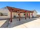 Back patio featuring a wood pergola, offering shaded outdoor living and entertaining space at 2950 Winchester Ave, Pahrump, NV 89048