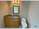 Cozy bathroom featuring a wood vanity and a toilet with a matching marble countertop at 4525 Dean Martin Dr # 2704, Las Vegas, NV 89103