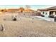 Xeriscaped backyard with patio area and block wall at 4700 E Brolio Ct, Pahrump, NV 89061