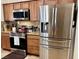 Modern kitchen featuring stainless steel appliances, granite counters, and wood cabinets at 4700 E Brolio Ct, Pahrump, NV 89061