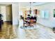 Bright open-concept living space with tile flooring, dining area and a view into the kitchen at 4700 E Brolio Ct, Pahrump, NV 89061