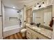 Stylish bathroom with tub, shower combo, granite vanity, and modern fixtures at 4963 Crooked Stick Way, Las Vegas, NV 89113