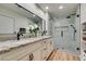 Bright bathroom boasts double vanity with granite counters and a large glass-enclosed shower at 4963 Crooked Stick Way, Las Vegas, NV 89113