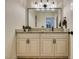 Bathroom featuring a granite countertop, framed mirror, updated vanity, and modern lighting at 4963 Crooked Stick Way, Las Vegas, NV 89113