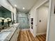 Bright bathroom featuring double sinks, and a glass shower enclosure at 4963 Crooked Stick Way, Las Vegas, NV 89113