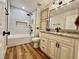 Bathroom featuring tub, with shower and vanity with granite countertop at 4963 Crooked Stick Way, Las Vegas, NV 89113