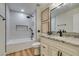Nicely appointed bathroom featuring granite counters, tub with shower, and decorative wall art at 4963 Crooked Stick Way, Las Vegas, NV 89113