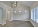 Well lit bedroom featuring plush carpet, decorative chandelier, and bright shuttered windows at 4963 Crooked Stick Way, Las Vegas, NV 89113